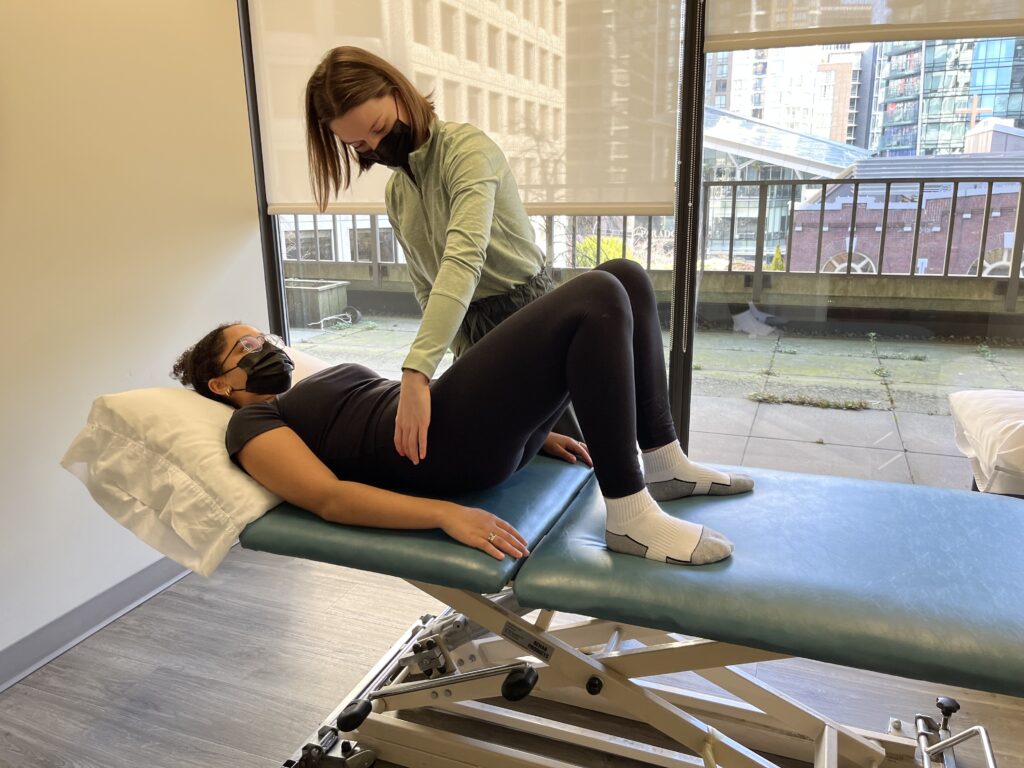 Pelvic Floor Physiotherapist Moriah Thorpe assisting patient in exercise