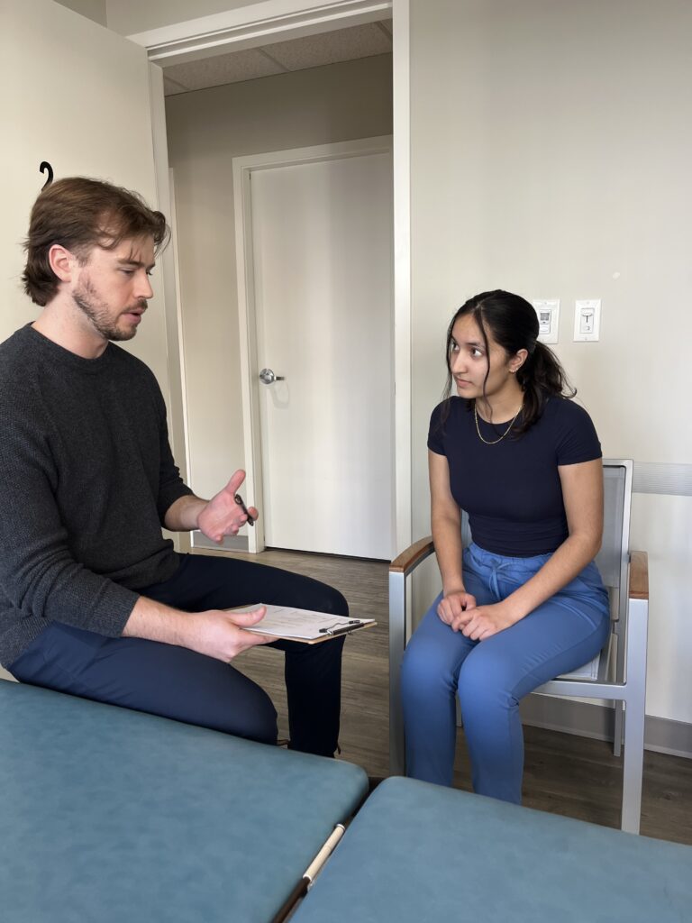 chiropractor explains plan of care to patient