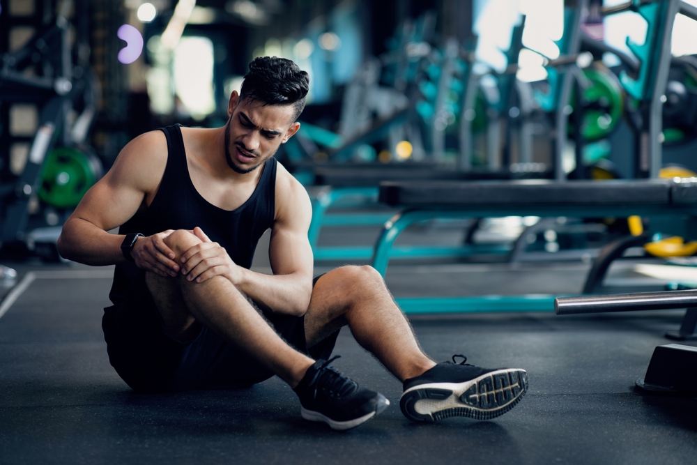 Man on the ground having knee pain