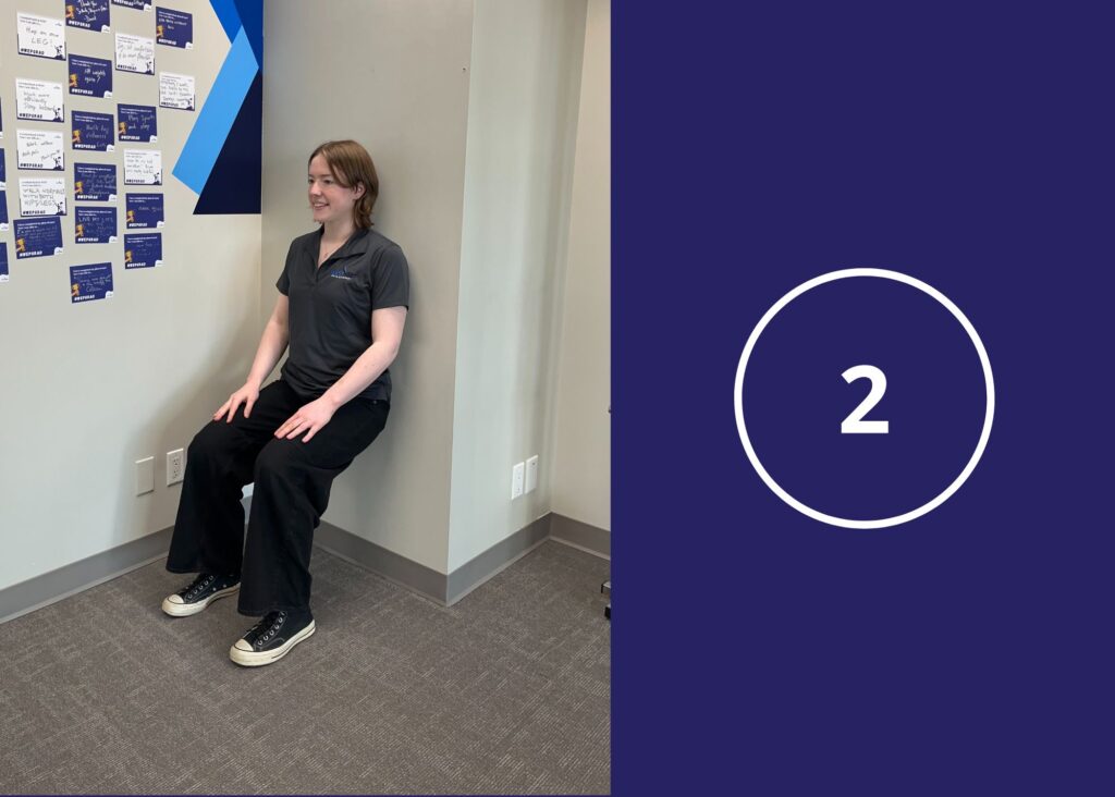 Step 2 of Wall Sit Exercise demonstrated by a co-op student